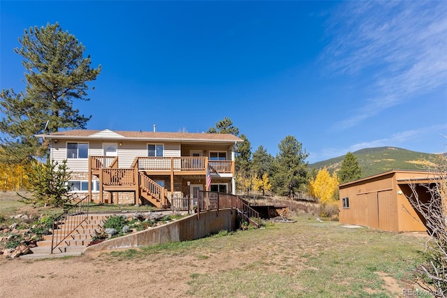 back of house featuring a deck with mountain view