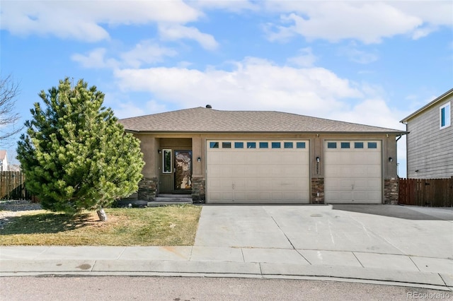 view of front of property with fence, driveway, stucco siding, a garage, and stone siding