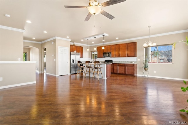 living area featuring ceiling fan with notable chandelier, crown molding, baseboards, and dark wood-style flooring