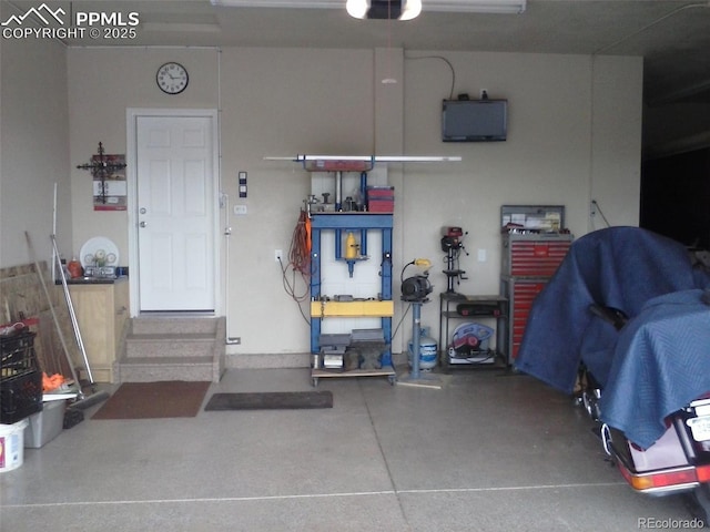 garage with a workshop area and a garage door opener