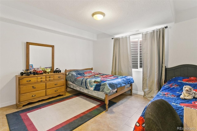 bedroom featuring tile patterned floors and a textured ceiling