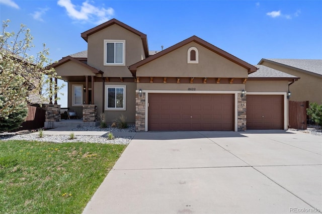 view of front facade with a garage, stucco siding, concrete driveway, and stone siding