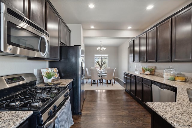 kitchen with stainless steel appliances, dark brown cabinetry, a chandelier, dark wood-style flooring, and recessed lighting