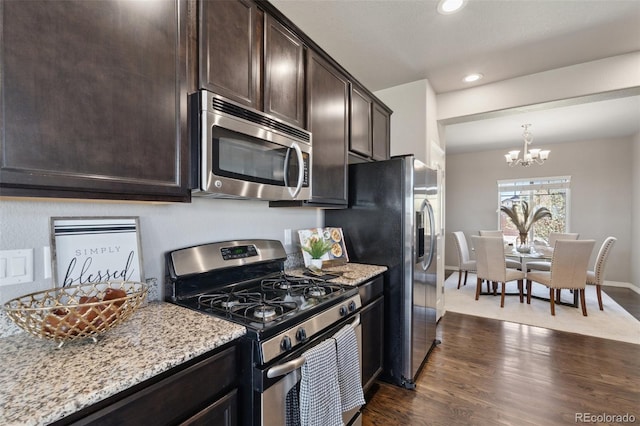 kitchen featuring appliances with stainless steel finishes, dark brown cabinets, dark wood-style flooring, a chandelier, and recessed lighting