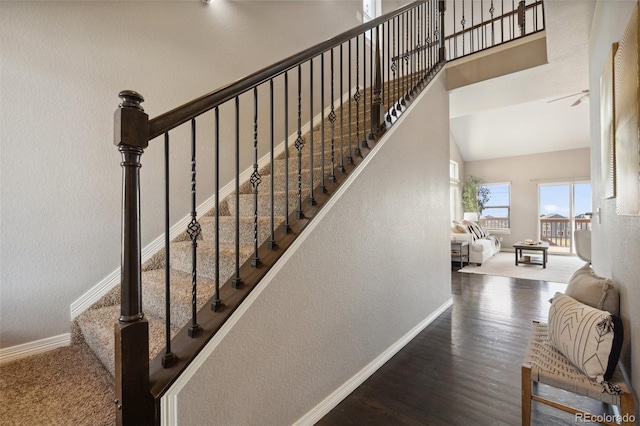 stairs with baseboards, a textured wall, and wood finished floors