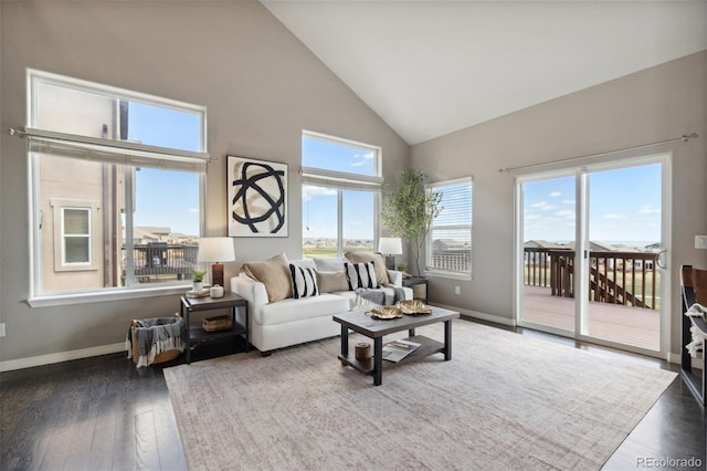 living room featuring high vaulted ceiling, wood finished floors, and baseboards