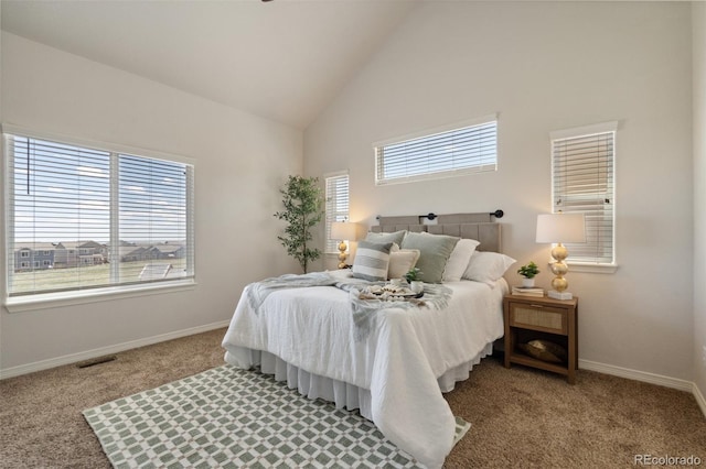 carpeted bedroom with high vaulted ceiling and baseboards