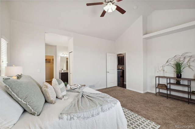 carpeted bedroom with high vaulted ceiling, baseboards, a spacious closet, ceiling fan, and ensuite bathroom