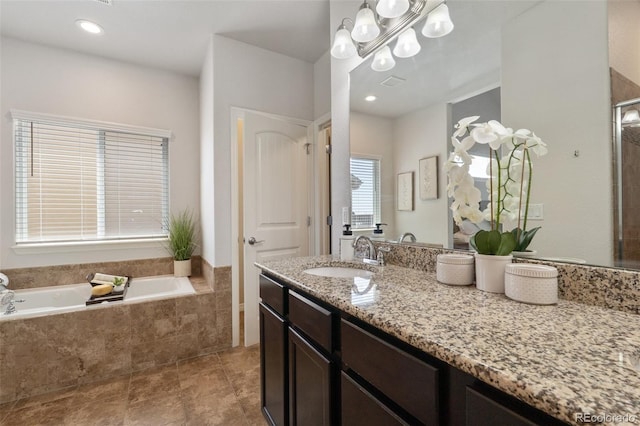full bath featuring a bath, vanity, and a chandelier
