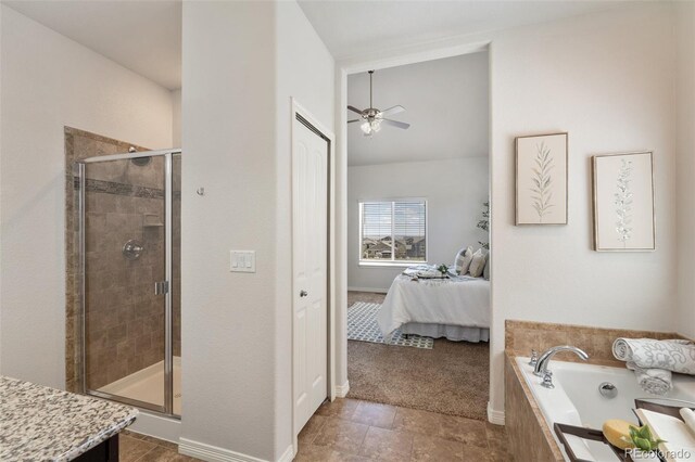 ensuite bathroom featuring a shower stall, a bath, a ceiling fan, lofted ceiling, and baseboards