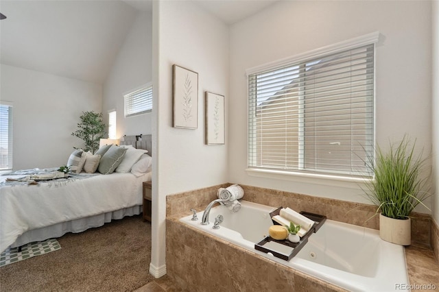 ensuite bathroom with a tub with jets and vaulted ceiling