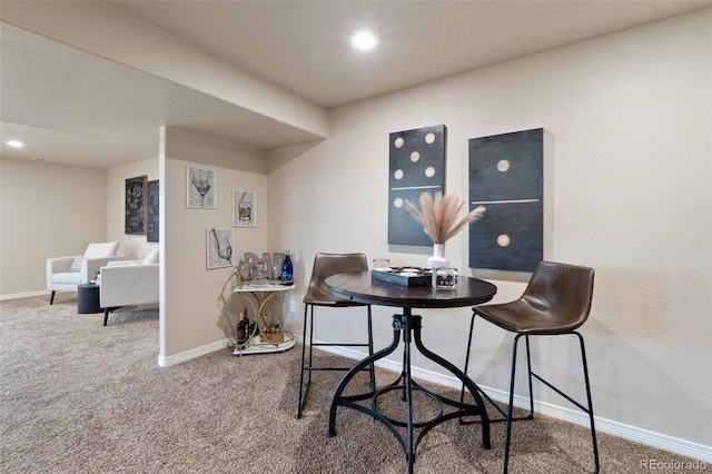 carpeted dining space with baseboards and recessed lighting