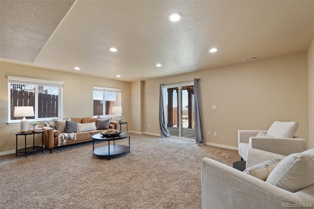 living room featuring light colored carpet, a textured ceiling, recessed lighting, and baseboards