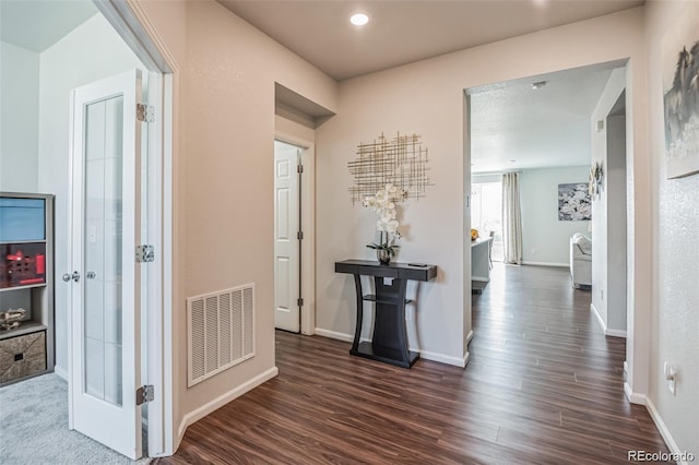 hallway with dark hardwood / wood-style floors