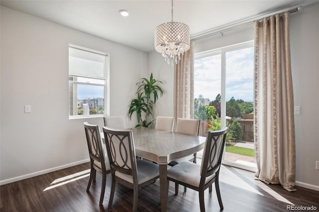 dining space with a chandelier, a wealth of natural light, and dark hardwood / wood-style flooring