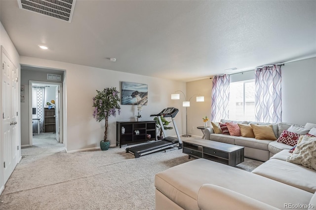 living room featuring light colored carpet and a textured ceiling