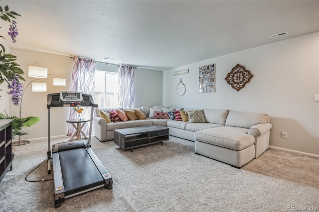 carpeted living room featuring a textured ceiling