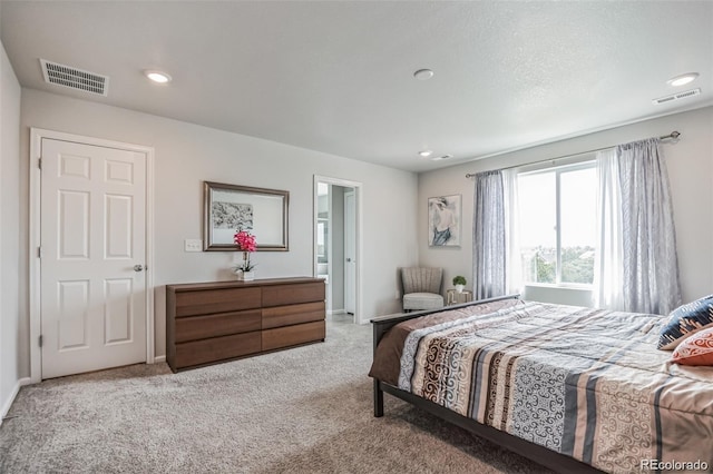 bedroom featuring light carpet