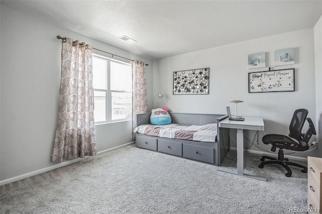 bedroom featuring a textured ceiling and carpet