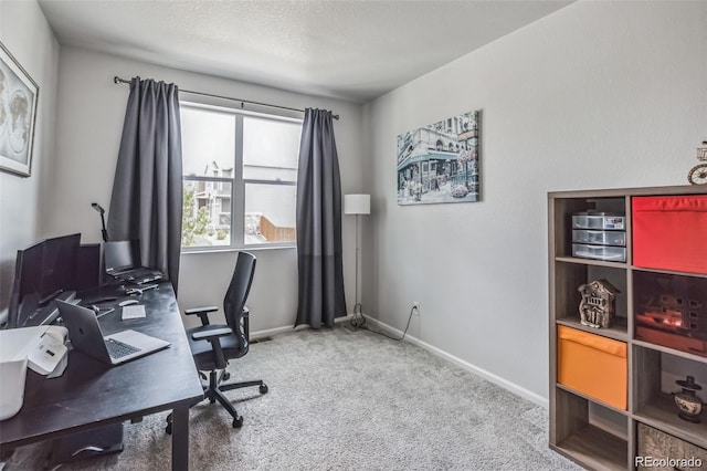 carpeted home office with a textured ceiling