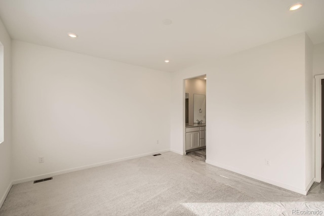 unfurnished room with light colored carpet