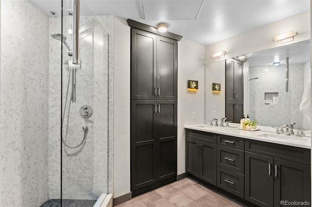 bathroom with a tile shower and vanity