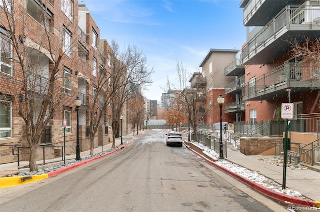 1438 Little Raven St Unit 407, Denver, CO 80202 - view of asphalt road featuring sidewalks, curbs, street lighting, and traffic signs