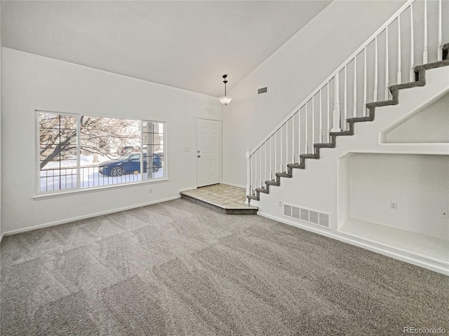 interior space with carpet floors and lofted ceiling