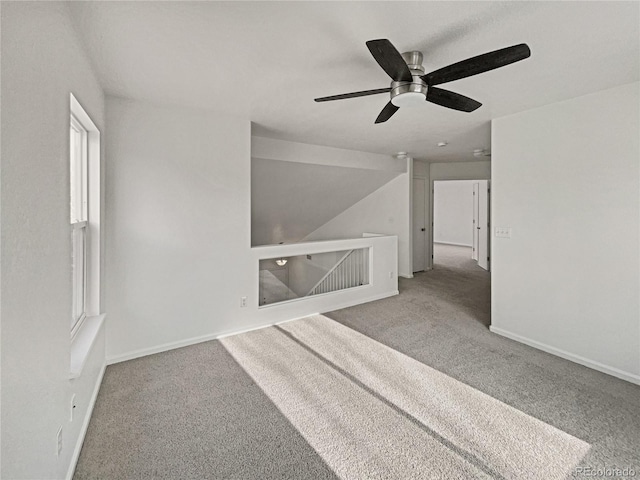 carpeted empty room featuring ceiling fan