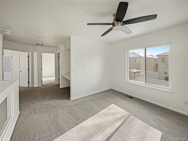 carpeted empty room featuring ceiling fan