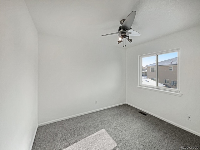 spare room with ceiling fan and carpet