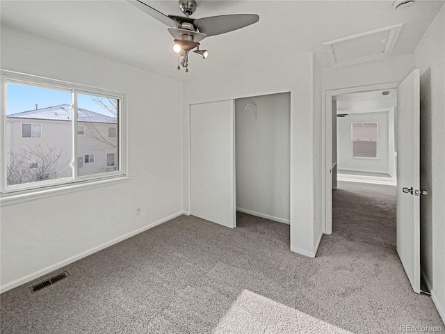 unfurnished bedroom with carpet flooring, ceiling fan, and a closet