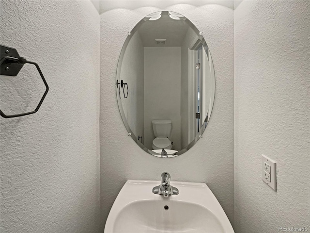 bathroom featuring sink and toilet