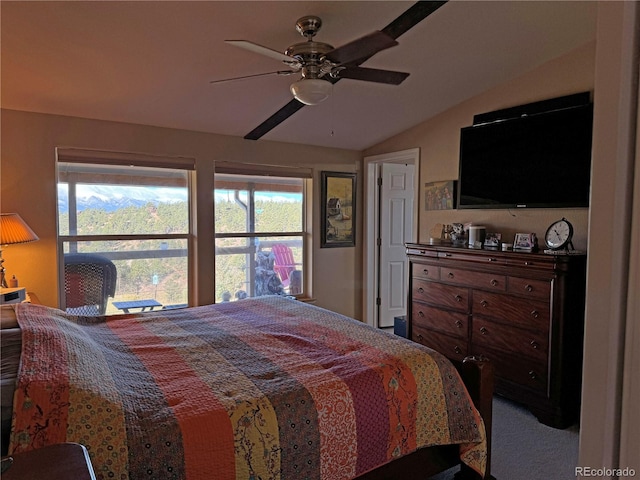 bedroom featuring ceiling fan, vaulted ceiling, and carpet floors