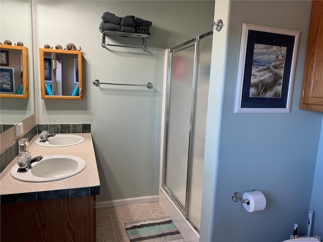 bathroom featuring vanity, tile patterned floors, and a shower with shower door