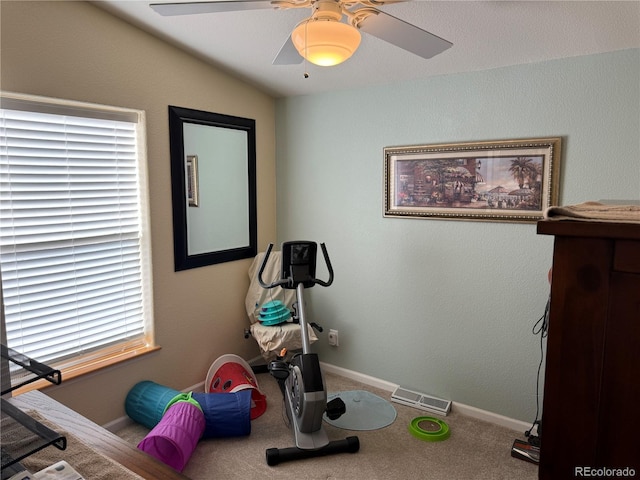 exercise area with lofted ceiling, carpet floors, and ceiling fan