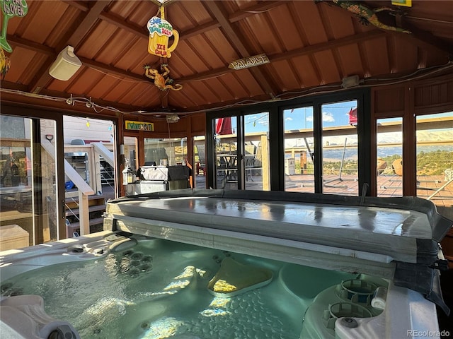 unfurnished sunroom with wood ceiling and lofted ceiling with beams