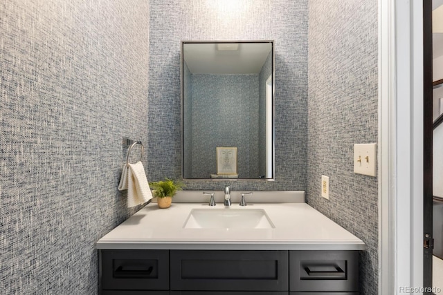 bathroom featuring vanity and tile walls