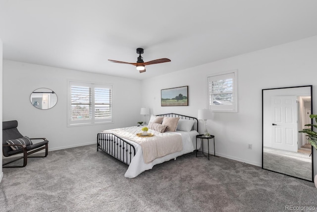 carpeted bedroom with a ceiling fan and baseboards