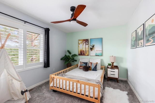 carpeted bedroom with a ceiling fan and baseboards