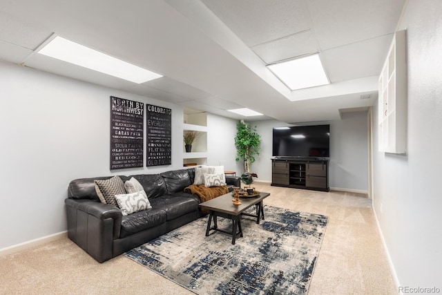 living area with carpet flooring, visible vents, and baseboards