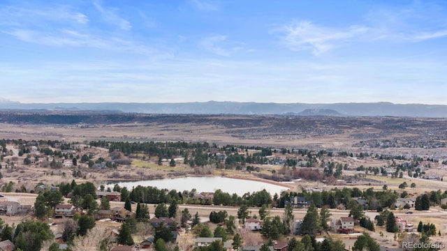 birds eye view of property featuring a water and mountain view