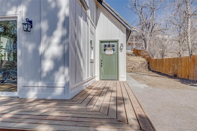 view of exterior entry featuring fence