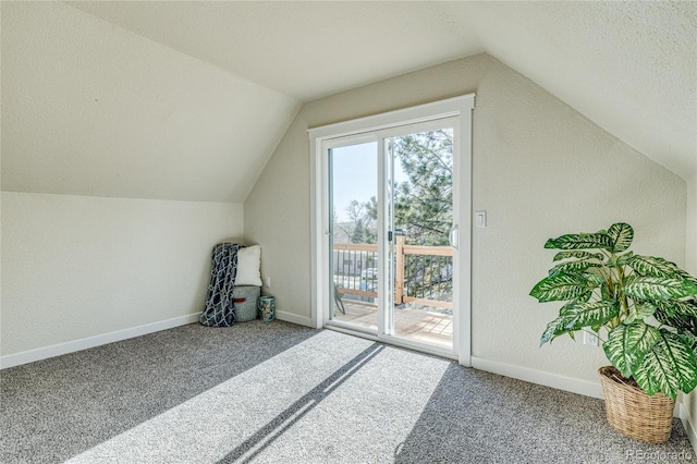 additional living space featuring carpet, vaulted ceiling, and baseboards