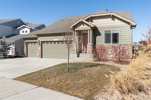 craftsman inspired home with a garage, driveway, stone siding, roof with shingles, and a front yard