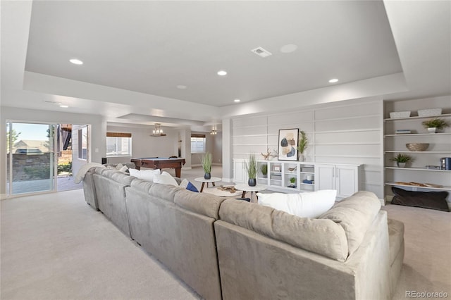 living room featuring light carpet, recessed lighting, a tray ceiling, and pool table