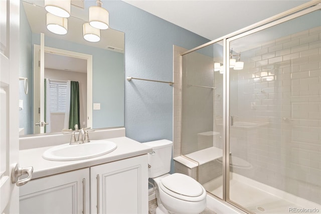 full bathroom featuring visible vents, a stall shower, vanity, and toilet