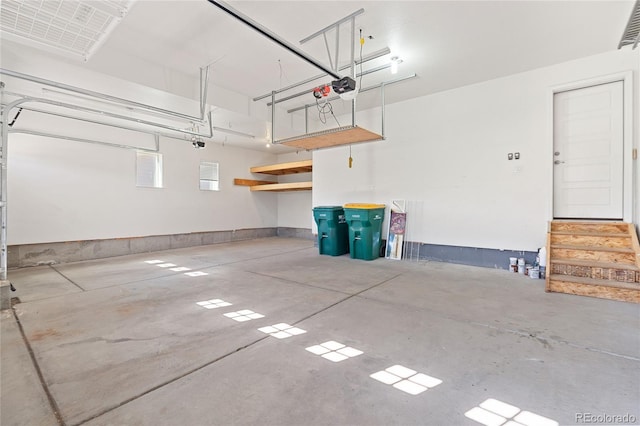 garage featuring visible vents and a garage door opener