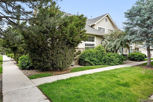 10010 E Gunnison Pl Unit 707, Aurora, CO 80247 - view of property exterior featuring a yard and a shingled roof