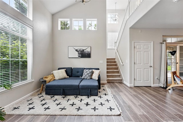 10010 E Gunnison Pl Unit 707, Aurora, CO 80247 - living area with healthy amount of natural light, stairs, high vaulted ceiling, wood finished floors, and baseboards